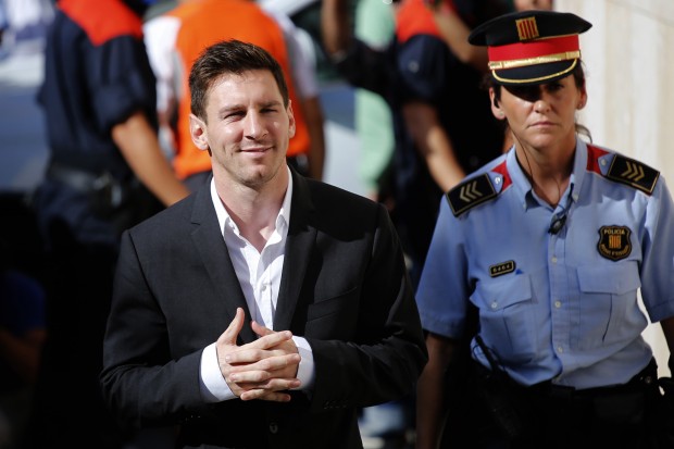  In this Sept. 27, 2013 file photo, FC Barcelona star Lionel Messi, left, arrives at a court to answer questions in a tax fraud case in Gava, near Barcelona, Spain. Lionel Messi will stand trial in Spain on three counts of tax fraud and could be sentenced to nearly two years in prison if found guilty. Court documents made public Thursday said a judge has rejected a request to clear the Barcelona player of wrongdoing and decided to charge him and his father, Jorge Horacio Messi, with tax fraud. (AP Photo/Emilio Morenatti, File)