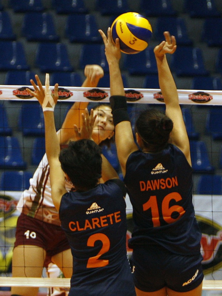UP’s Isabel Molde hammers in a kill against Coast Guard’s Nelet Clarete and Sam Dawson during their Shakey’s V-League Reinforced Conference clash.