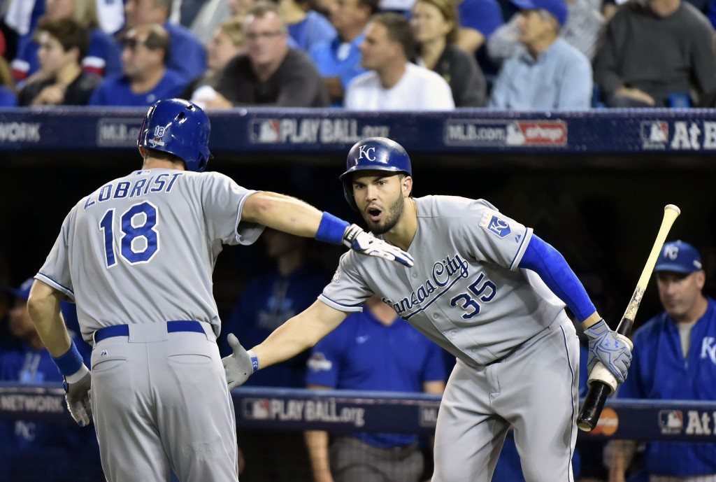 Kansas City Royals' Ben Zobrist (18) celebrates his two-run home run with teammate Eric Hosmer (35) during the first inning in Game 4 of baseball's American League Championship Series on Tuesday, Oct. 20, 2015, in Toronto. (Nathan Denette/The Canadian Press via AP) MANDATORY CREDIT