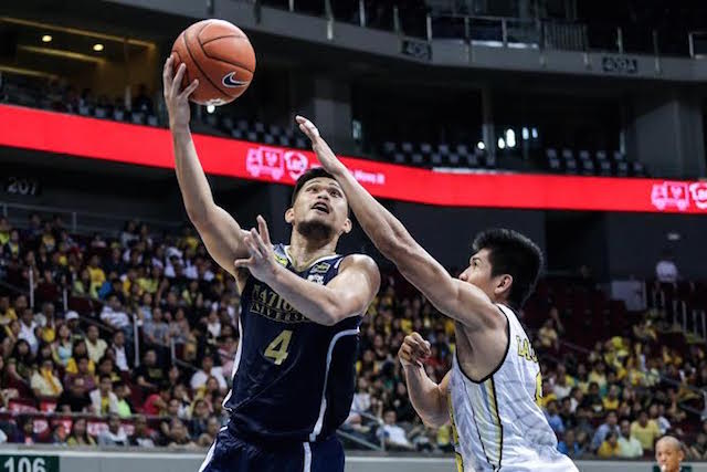 NU guard Gelo Alolino takes a layup against the defense of UST's Ed Daquioag. Tristan Tamayo/INQUIRER.net