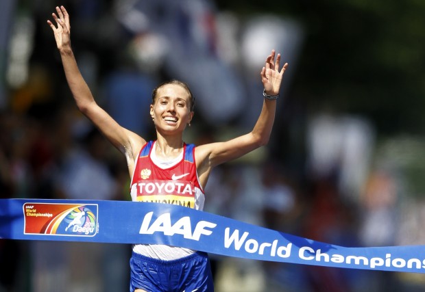 FILE - In this Aug. 31, 2011 file photo Russia's Olga Kaniskina reacts as she crosses the finish line to win the Women's 20km Race Walk at the World Athletics Championships in Daegu, South Korea. WADA's independent commission said Monday, Nov. 9, 2015 Russia's athletics federation should be suspended and its track and field athletes banned from competition until the country cleans up its act on doping. (AP Photo/Lee Jin-man, file)