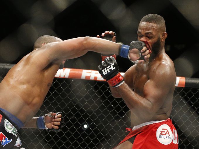 Daniel Cormier lands a solid right to the face of Jon Jones during their fight at UFC 182 last January. AP