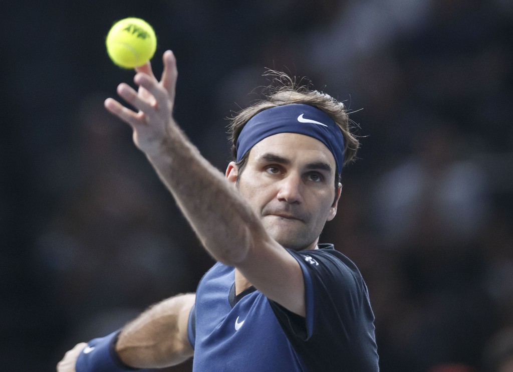 Switzerland's Roger Feder serves the ball to American's John Isner during their third round match of the BNP Masters tennis tournament at the Paris Bercy Arena, in Paris, France, Thursday, Nov. 5, 2015. AP