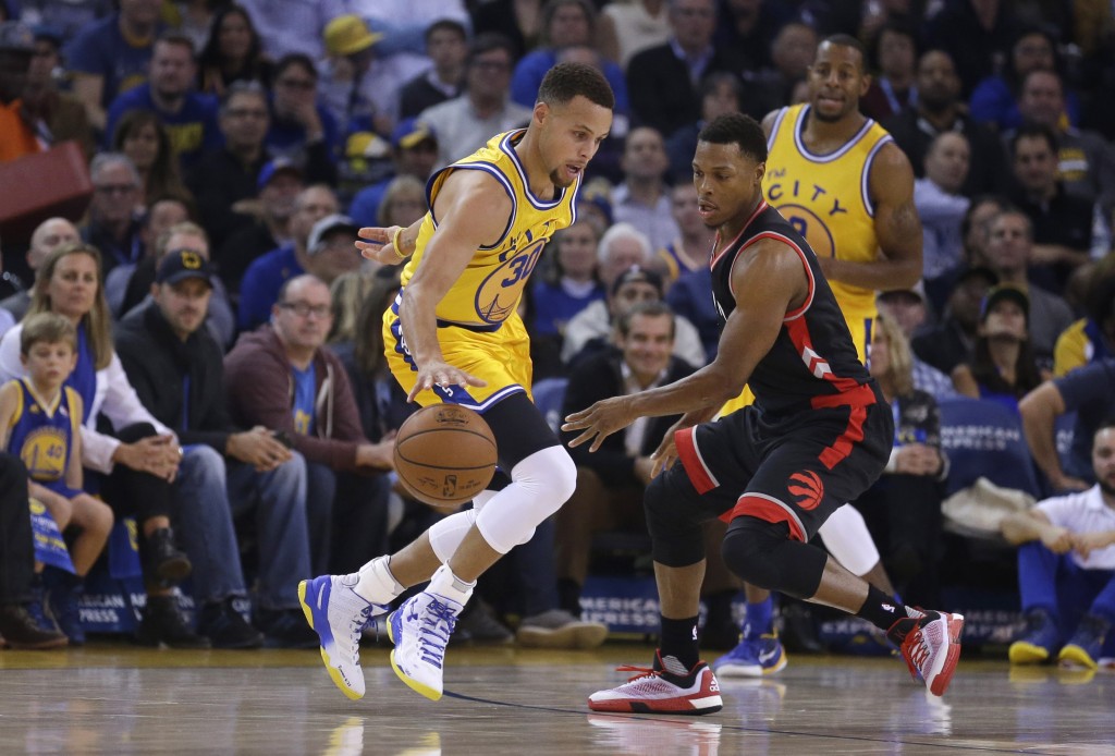 Golden State Warriors' Stephen Curry, left, drives the ball against Toronto Raptors' Kyle Lowry during the first half of an NBA basketball game Tuesday, Nov. 17, 2015, in Oakland, Calif. (AP Photo/Ben Margot)