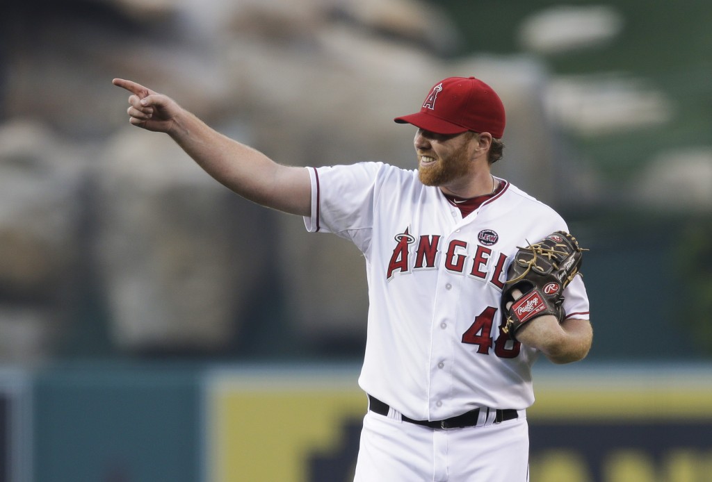 In this May 31, 2013, file photo, Los Angeles Angels starting pitcher Tommy Hanson points to a teammate during the first inning of a baseball game against the Houston Astros in Anaheim, California. AP