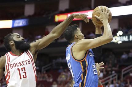 Oklahoma City Thunder's Andre Roberson, right, shoots as Houston Rockets' James Harden (13) defends in the first half of an NBA basketball game Monday, Nov. 2, 2015, in Houston. (AP Photo/Pat Sullivan)