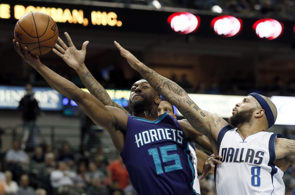 Charlotte Hornets guard Kemba Walker (15) goes up for a shot as Dallas Mavericks' Deron Williams (8) and Jeremy Lamb, rear, defend duirng the first half of an NBA basketball game Thursday, Nov. 5, 2015, in Dallas. AP