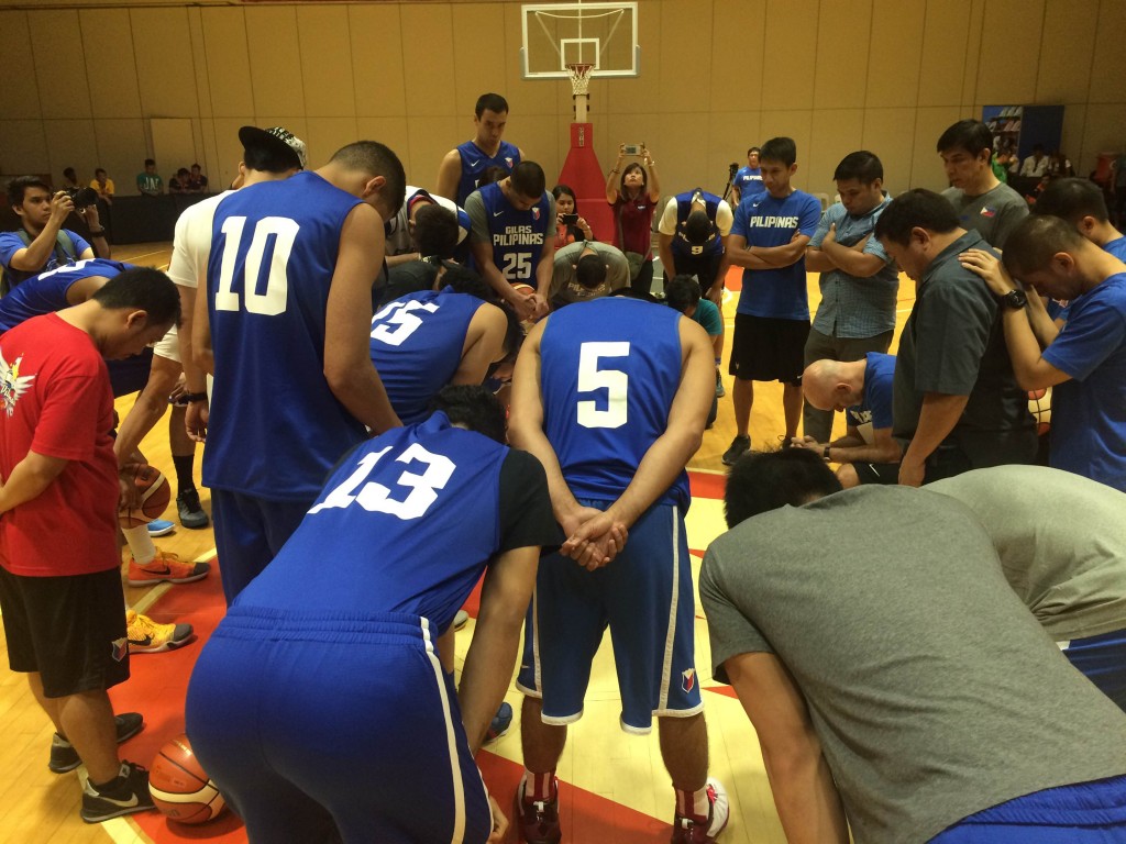 June Mar Fajardo and the rest of the Gilas Pilipinas pool huddle at center court during their first practice Monday night at Meralco gym. Mark Giongco