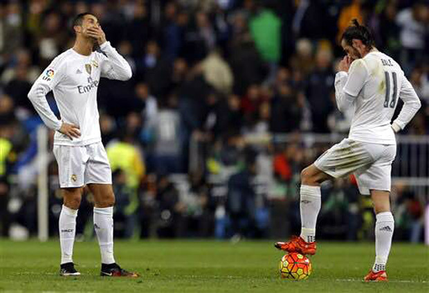 Real Madrid's Cristiano Ronaldo reacts next to Gareth Bale, right, as Barcelona's Luis Suarez celebrates with teammates after scoring his side’s fourth goal during the first clasico of the season between Real Madrid and Barcelona at the Santiago Bernabeu stadium in Madrid, Spain, Saturday, Nov. 21, 2015. AP 