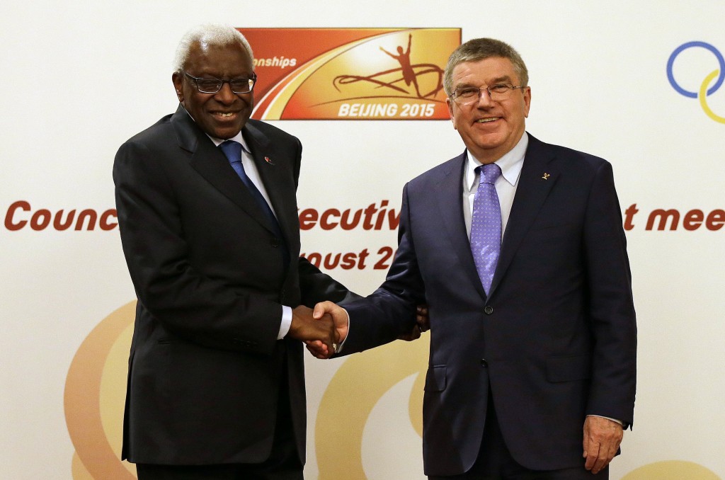  In this Friday, Aug. 21, 2015 file photo, IOC president Thomas Bach, right, shakes hands with IAAF president Lamine Diack during a joint IOC and IAAF press conference on the side of the World Athletic Championships in Beijing. AP 