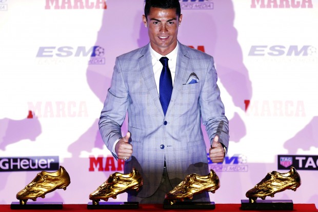 Real Madrid's striker Cristiano Ronaldo poses with the Golden Boot award for scoring the most goals in Europe's domestic leagues last season, during a ceremony in Madrid, Spain, Tuesday, Oct. 13, 2015. This is the fourth Golden Boot award Ronaldo has won during his career and his third since joining Real Madrid, where he scored 48 goals during the last La Liga season. (AP Photo/Francisco Seco)