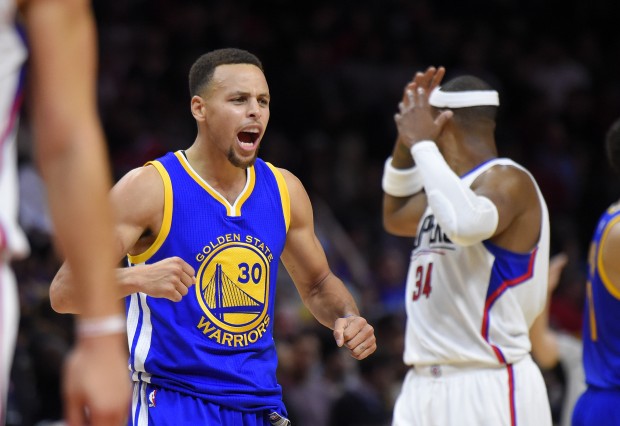 Golden State Warriors guard Stephen Curry, left, celebrates near Los Angeles Clippers forward Paul Pierce during the second half of an NBA basketball game, Thursday, Nov. 19, 2015, in Los Angeles. The Warriors won 124-117. (AP Photo/Mark J. Terrill)