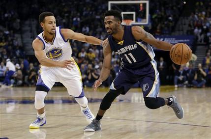 Memphis Grizzlies' Mike Conley (11) dribbles next to Golden State Warriors' Stephen Curry (30). AP