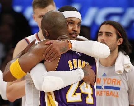 New York Knicks forward Carmelo Anthony (7) embraces Los Angeles Lakers forward Kobe Bryant (24) at the end of an NBA basketball game at Madison Square Garden in New York, Sunday, Nov. 8, 2015. The Knicks defeated the Lakers 99-95. AP