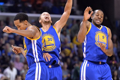 Golden State Warriors guards Shaun Livingston, left, Stephen Curry (30), and Andre Iguodala (9) celebrate after Curry's three-point score to beat the buzzer at the end of the third quarter during an NBA basketball game against the Memphis Grizzlies, Wednesday, Nov. 11, 2015, in Memphis, Tenn. AP PHOTO