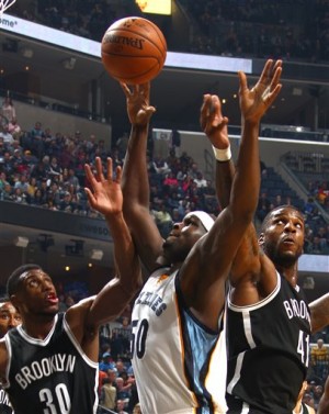 Memphis Grizzlies' Zach Randolph, center, battles for a rebound with Brooklyn Nets' Thaddeus Young, left, and Thomas Robinson during an NBA basketball game Saturday, Oct. 31, 2015, in Memphis, Tenn. (Nikki Boertman/The Commercial Appeal via AP) MANDATORY CREDIT