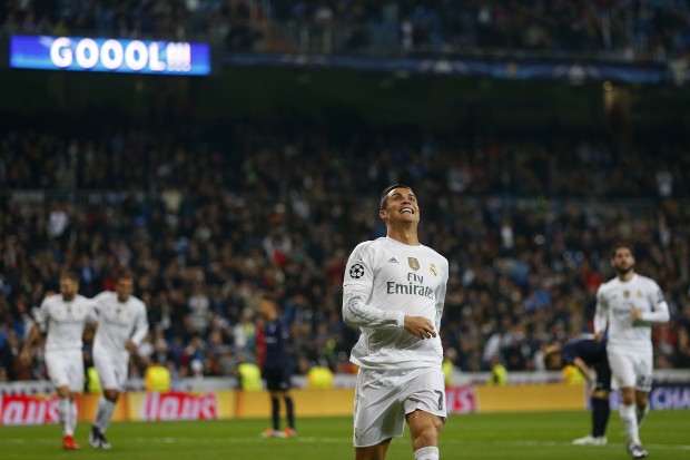 Real Madrid's Cristiano Ronaldo, center, celebrates scoring his side's 4th goal during a Champions League group A soccer match between Real Madrid and Malmo at the Santiago Bernabeu stadium in Madrid, Tuesday, Dec. 8, 2015. (AP Photo/Francisco Seco)