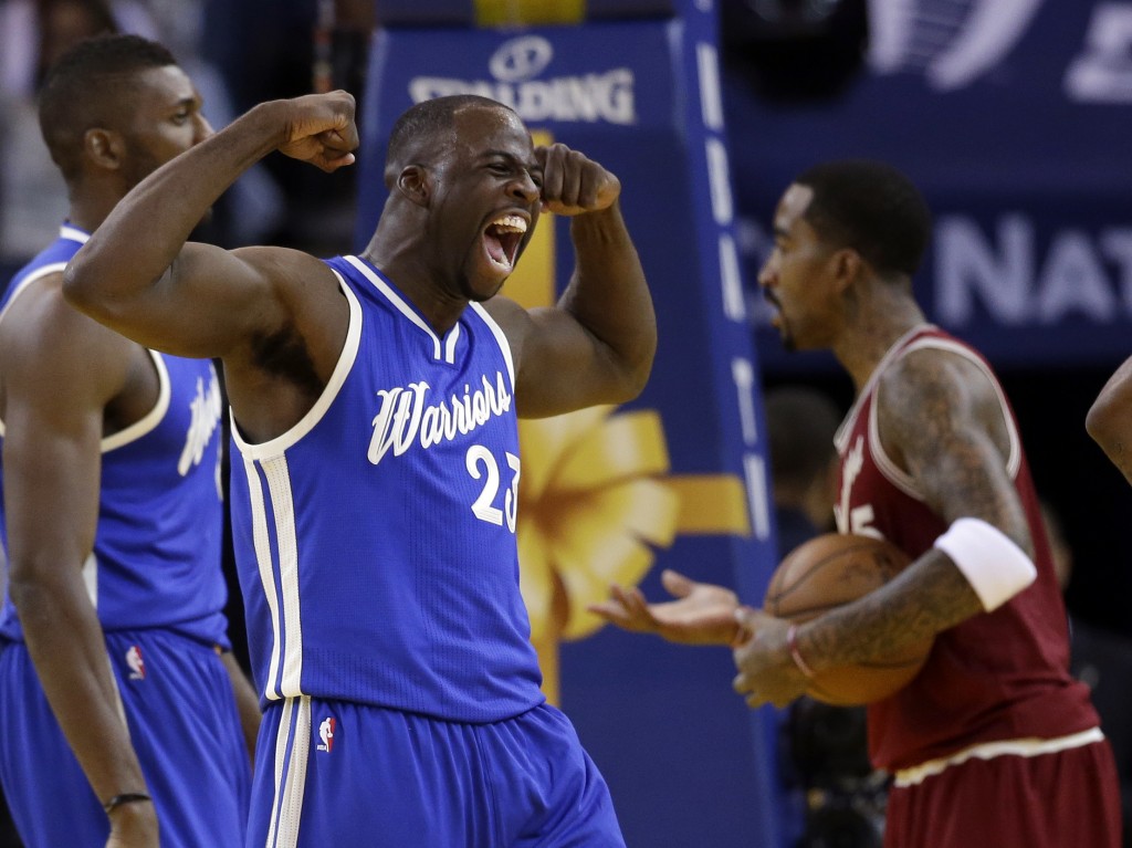 Golden State Warriors' Draymond Green (23) celebrates after scoring against the Cleveland Cavaliers during the first half of an NBA basketball game Friday, Dec. 25, 2015, in Oakland, California. AP