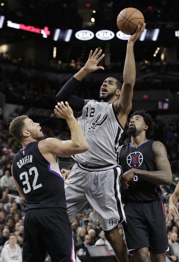 San Antonio Spurs forward LaMarcus Aldridge (12) shoots over Los Angeles Clippers forward Blake Griffin (32) and in front of center DeAndre Jordan (6) during the second half of an NBA basketball game, Friday, Dec. 18, 2015, in San Antonio. San Antonio won 115-107. (AP Photo/Eric Gay)
