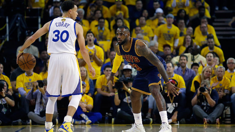 Golden State Warriors' Steph Curry being guarded by Cleveland Cavaliers' LeBron James  during the NBA Finals last June. AP
