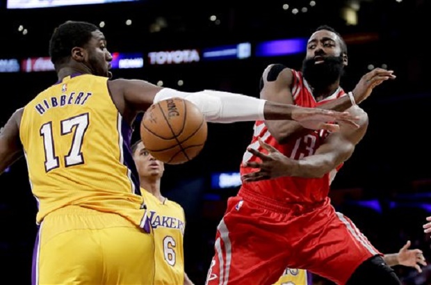Houston Rockets guard James Harden, right, passes around Los Angeles Lakers center Roy Hibbert. AP