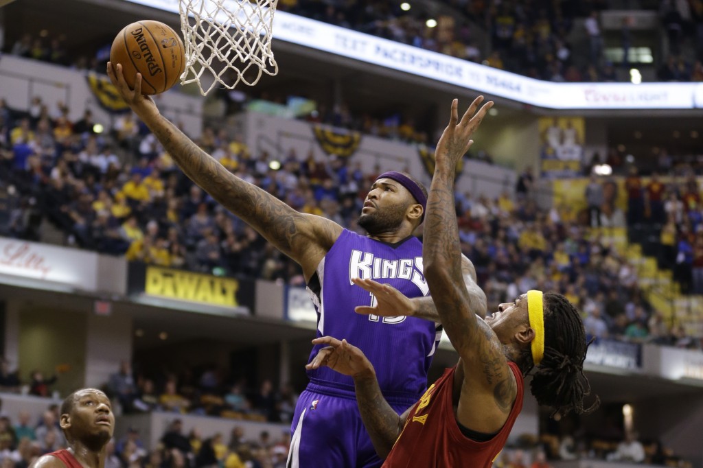 Sacramento Kings forward DeMarcus Cousins (15) shoots in front of Indiana Pacers center Jordan Hill, right, during the first half of an NBA basketball game in Indianapolis, Wednesday, Dec. 23, 2015. (AP Photo/Michael Conroy)