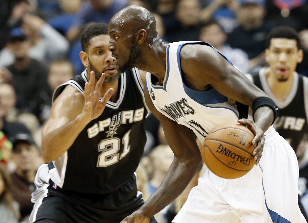 Minnesota Timberwolves’ Kevin Garnett, right, drives by San Antonio Spurs’ Tim Duncan in the first quarter of an NBA basketball game, Wednesday, Dec. 23, 2015, in Minneapolis. (AP Photo/Jim Mone)