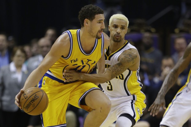 Indiana Pacers guard George Hill (3) tries to tie up Golden State Warriors guard Klay Thompson (11) during the second half of an NBA basketball game in Indianapolis, Tuesday, Dec. 8, 2015. The Warrior defeated the Pacers 131-123. (AP Photo/Michael Conroy)