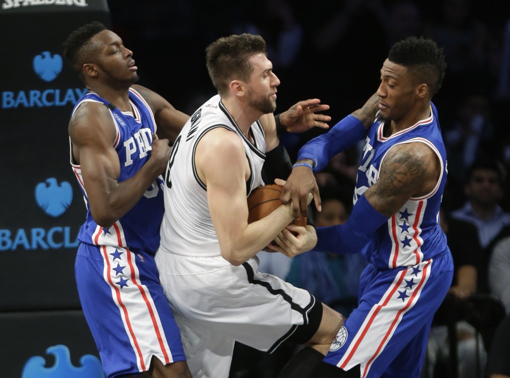 Philadelphia 76ers' Jerami Grant, left, and Robert Covington, right, fight for control of the ball with Brooklyn Nets' Andrea Bargnani, center, during the second half of an NBA basketball game Thursday, Dec. 10, 2015, in New York. The Nets won 100-91. (AP Photo/Frank Franklin II)