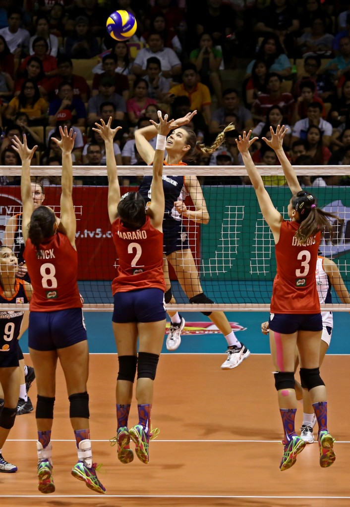 PHILIPPINE SUPER LIGA/ DECEMBER 5 2015 Lindsay Stalzer of Foton Tornadoes and Rupia Inck Furtado, Abigail Mariano, Rachel Anne Daquis of Petron Blaze Spikers during PSL volleyball championship at Cuneta Astrodome, Saturday. INQUIRER PHOTO/ KIMBERLY DELA CRUZ