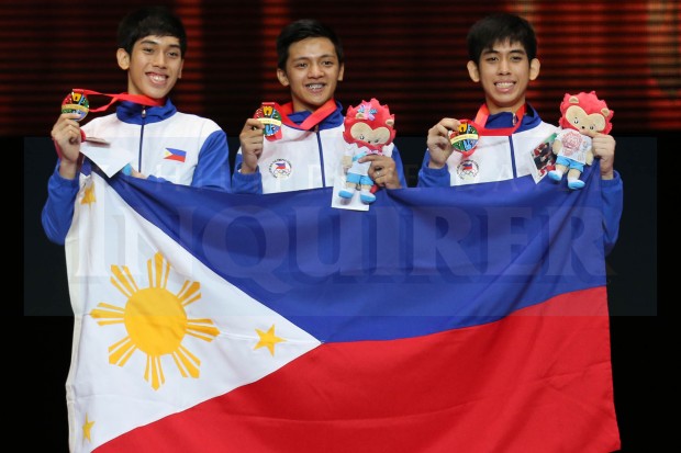Philippines Taekwondo Men's Poomsae team Dustin Jacob Mella, Rodolfo Reyes Jr. and Raphael Enrico Mella wins the gold in 28th SEA Games held at the Singapore Expo Hall 2 on June 12, 2015. INQUIRER PHOTO/RAFFY LERMA