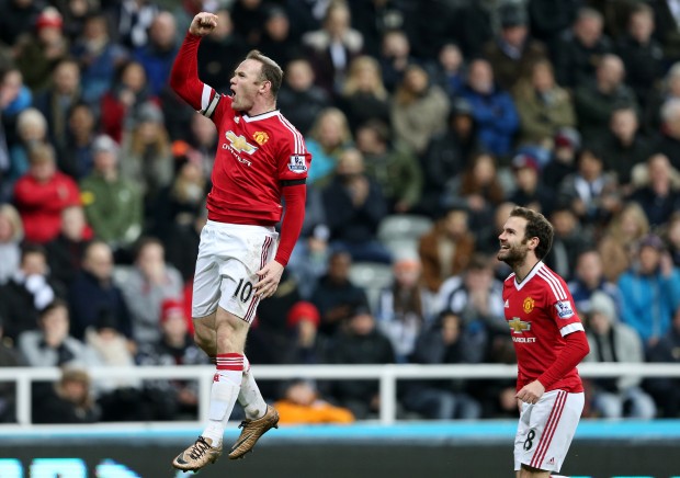 Manchester United's Wayne Rooney, left, celebrates his goal during the English Premier League soccer match between Newcastle United and Manchester United at St James' Park, Newcastle, England, Tuesday, Jan. 12, 2015. (AP Photo/Scott Heppell)