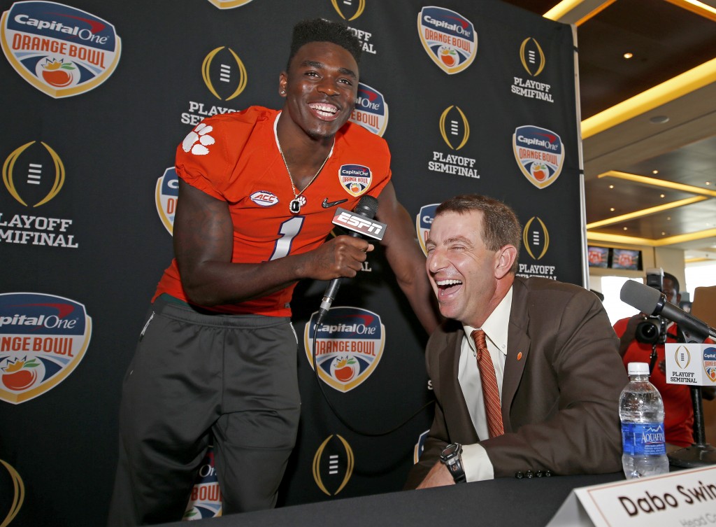 Clemson head coach Dabo Swinney laughs as he is "interviewed" by safety Jayron Kearse during Orange Bowl media day at Sun Life Stadium Tuesday, Dec. 29, 2015, in Miami Gardens, Fla. Clemson is scheduled to play Oklahoma in the Orange Bowl NCAA college football game on New Year's Eve. (AP Photo/Joe Skipper)