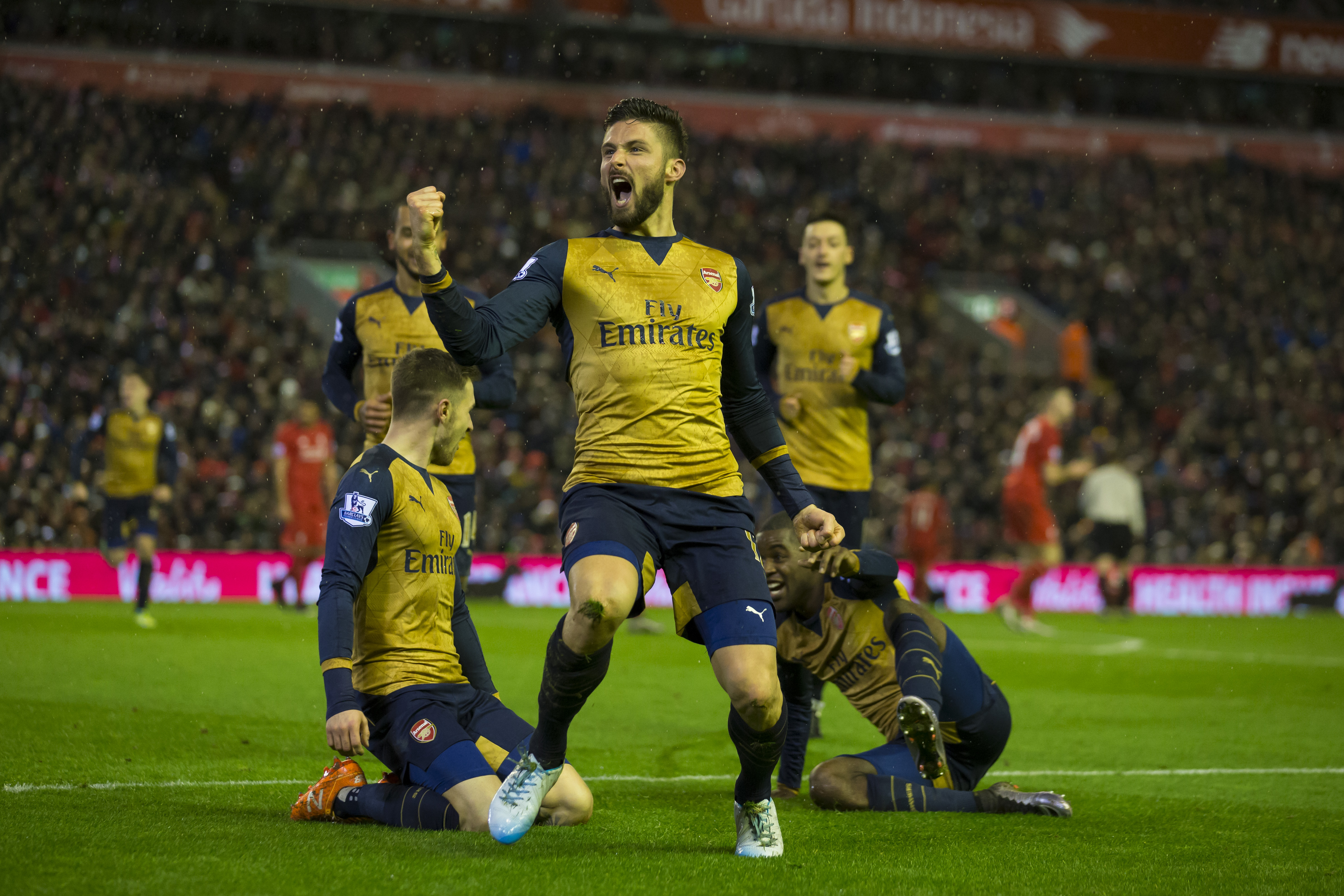 Arsenal's Olivier Giroud, centre, celebrates with teammates after scoring his second goal during the English Premier League soccer match between Liverpool and Arsenal at Anfield Stadium, Liverpool, England, Wednesday, Jan. 13, 2016. AP