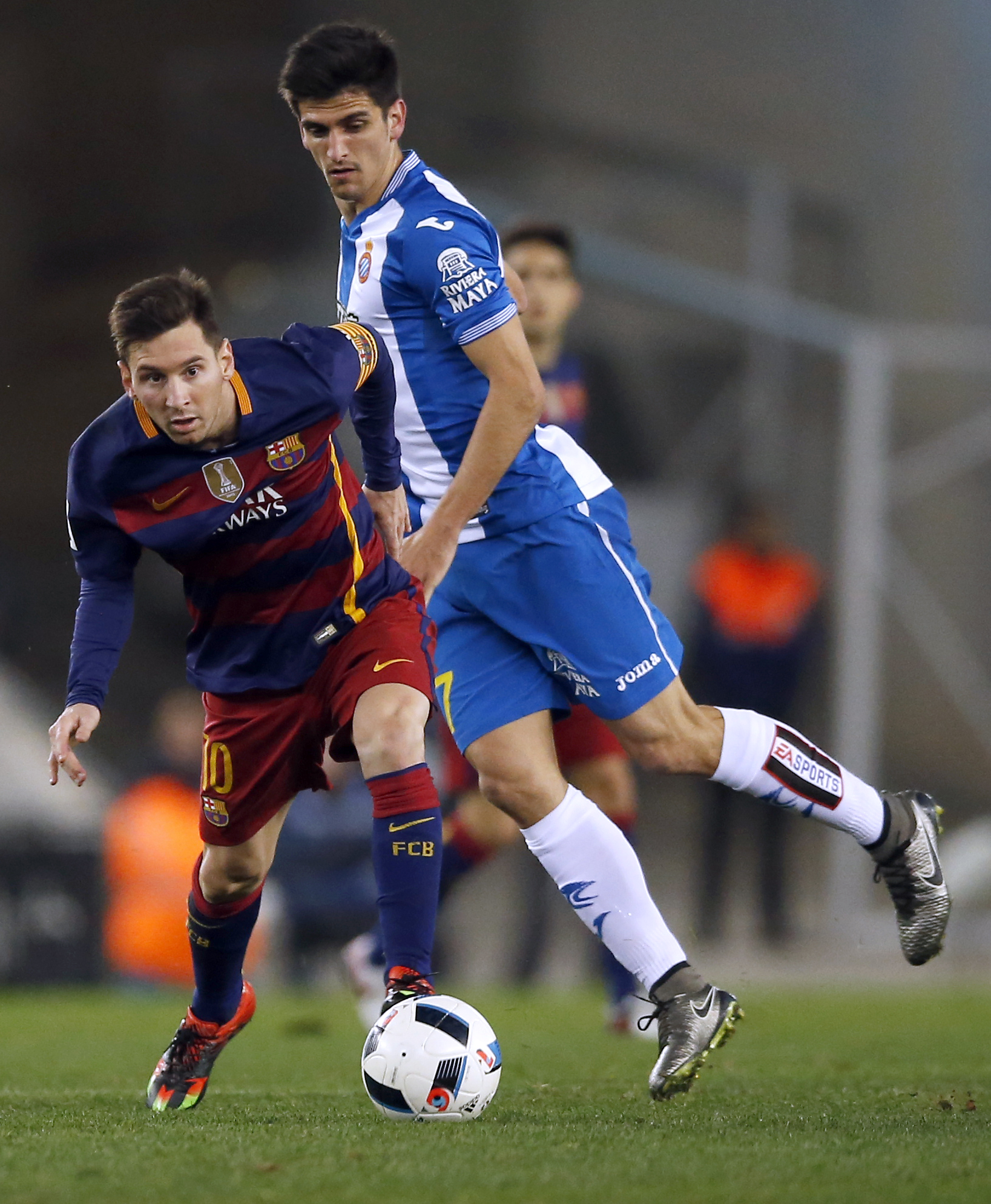 FC Barcelona's Lionel Messi, left, duels for the ball against Espanyol's Gerard Moreno during a Copa del Rey soccer match at RCDE stadium in Barcelona, Spain, Wednesday, Jan. 13, 2016. AP