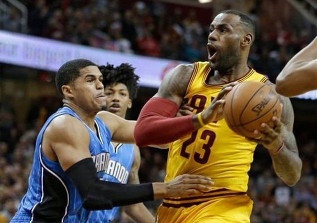 Cleveland Cavaliers' LeBron James, right, drives past Orlando Magic's Tobias Harris in the first half of an NBA basketball game Saturday, Jan. 2, 2016, in Cleveland. AP
