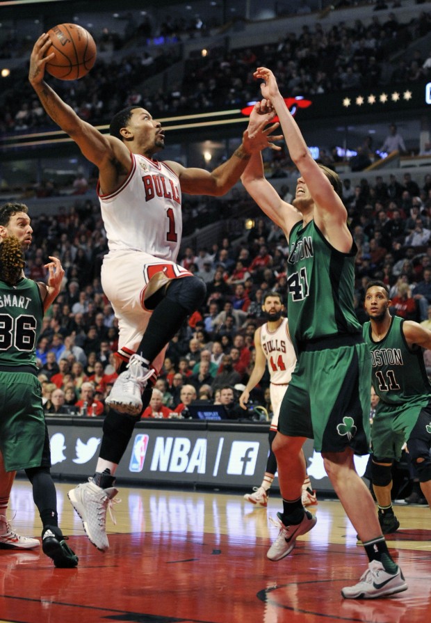 Chicago Bulls' Derrick Rose (1), goes up for a shot against Boston Celtics' Kelly Olynyk (41), during the second half of an NBA basketball game Thursday, Jan. 7, 2016, in Chicago. Chicago won 101-92. (AP Photo/Paul Beaty)