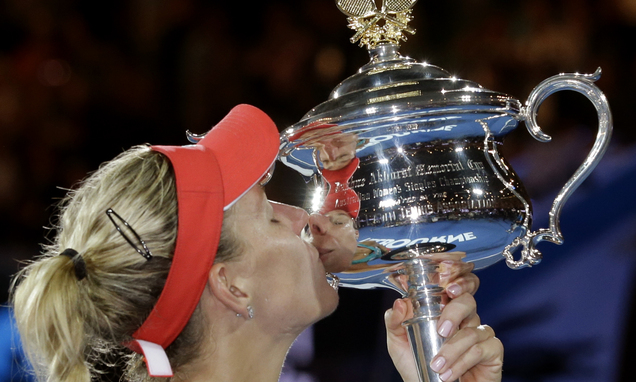 Angelique Kerber of Germany kisses the trophy after defeating Serena Williams of the United States in the women's singles final at the Australian Open tennis championships in Melbourne, Australia, Saturday, Jan. 30, 2016. AP
