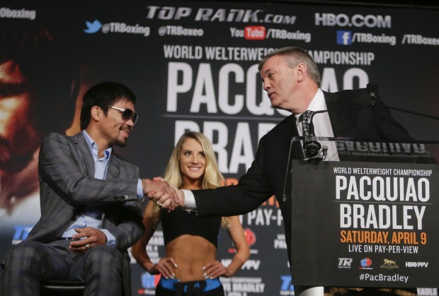 Manny Pacquiao, left, shakes hands with trainer Teddy Atlas, right, during a news conference to promote an upcoming boxing match Thursday, Jan. 21, 2016, in New York. Pacquiao is scheduled to fight Timothy Bradley on April 9, 2016,  in Las Vegas.  (AP Photo/Frank Franklin II)