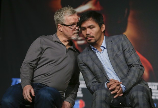 Trainer Freddie Roach, left, talks to Manny Pacquiao during a news conference to promote an upcoming boxing match against Timothy Bradley Thursday, Jan. 21, 2016, in New York. Pacquiao is scheduled to fight Bradley on April 9, 2016,  in Las Vegas. (AP Photo/Frank Franklin II)