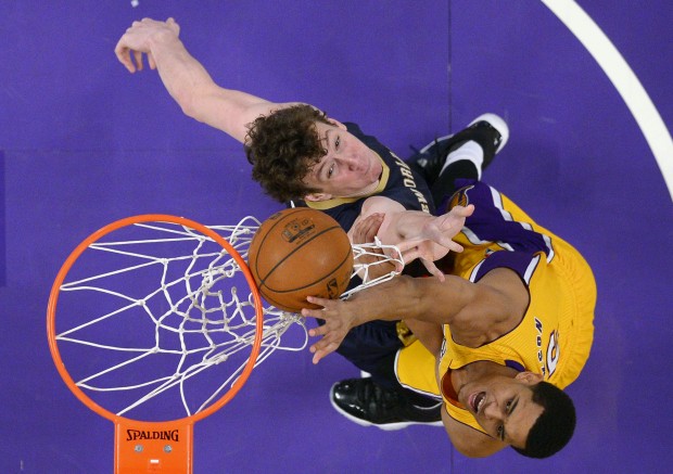New Orleans Pelicans center Omer Asik, left, and Los Angeles Lakers guard Jordan Clarkson reach for a rebound during the first half of an NBA basketball game, Tuesday, Jan. 12, 2016, in Los Angeles. (AP Photo/Mark J. Terrill)