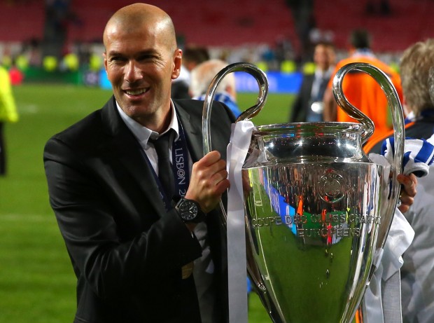 FILE - In this May 24, 2014 file photo, former player and current Real Madrid B team coach Zinedine Zidane lifts the Champion League trophy, at the end of the Champions League final soccer match between Atletico Madrid and Real Madrid in Lisbon, Portugal. Real Madrids President Florentino Perez announced Monday Jan. 4, 2016 that current coach Rafael Benitez has been fired and former player and Real Madrids B team coach Zinedine Zidane will take over. Benitez, hired seven months ago, has been under pressure since a demoralizing 4-0 home loss to Barcelona in November. (AP Photo/Andres Kudacki, File)
