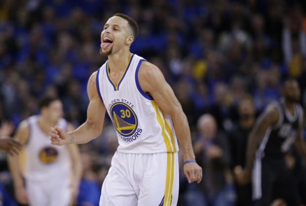 Golden State Warriors' Stephen Curry (30) celebrates after scoring against the San Antonio Spurs during the second half of an NBA basketball game Monday, Jan. 25, 2016, in Oakland, Calif. The Warriors won 120-90. (AP Photo/Marcio Jose Sanchez)