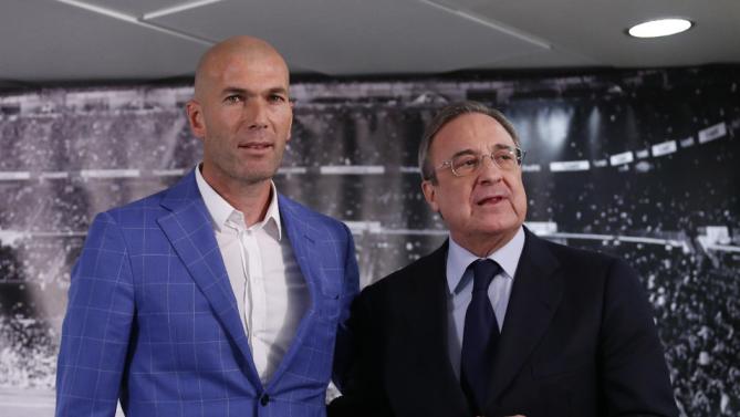 Real Madrid's President Florentino Perez, right, stands with newly appointed coach Zinedine Zidane at the Santiago Bernabeu stadium in Madrid, Spain, Monday Jan. 4, 2016. Real Madrid has fired coach Rafael Benitez after seven months and replaced him with former player Zinedine Zidane a day after Madrid's 2-2 draw at Valencia deepened a crisis that started with an embarrassing 4-0 home loss to rival Barcelona in November. AP
