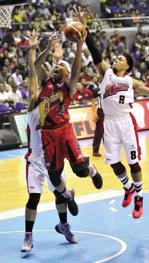 GABBY Espinas of San Miguel goes for a shot off Vic Manuel (left, partly hidden) and Calvin Abueva of Alaska during Game 1 of their PBA Philippine Cup Finals series last night. AUGUST DELA CRUZ
