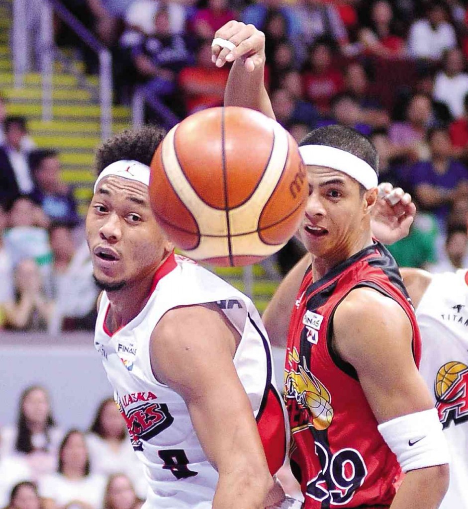 DO OR DIE  Arwind Santos of San Miguel Beer (right) hooks a pass against Alaska’s Calvin Abueva in last night’s winner-take-all  Game 7. The Beermen won, 96-89, to complete an unprecedented  four-game comeback and capture the Smart Bro-PBA Philippine Cup. (See story in Sports, Page A18.)  AUGUST DELA CRUZ