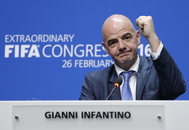 Newly elected FIFA president Gianni Infantino of Switzerland raises an arm during a press conference after the second election round during the extraordinary FIFA congress in Zurich, Switzerland, Friday, Feb. 26, 2016. Delegates of the soccer  body FIFA met to elect a new president. (AP Photo/Michael Probst)