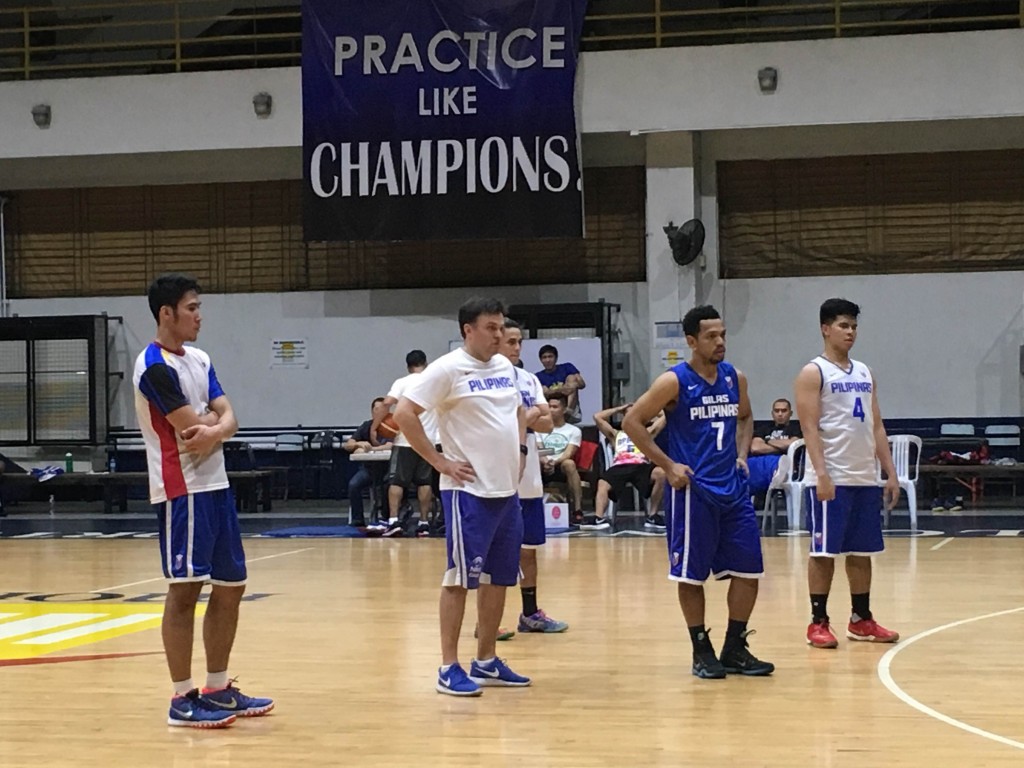 Mac Belo (left) looks on as Gilas Pilipinas head coach Tab Baldwin demontrates an offensive set during practice at Moro Lorenzo Sports Center. Mark Giongco/INQUIRER.net