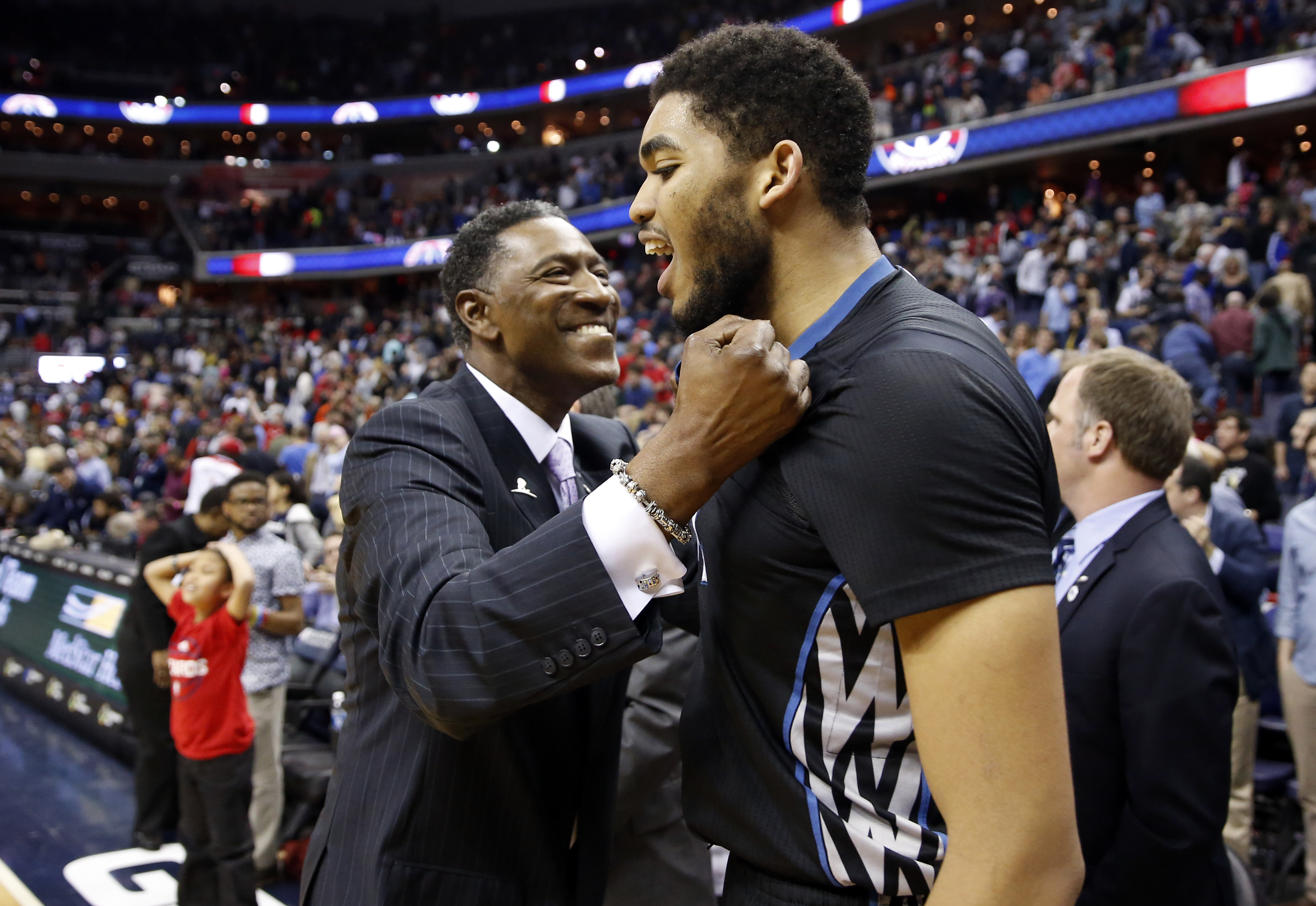 Minnesota Timberwolves coach Sam Mitchell celebrates with center Karl-Anthony Towns after the team's NBA basketball game against the Washington Wizards, Friday, March 25, 2016, in Washington. AP