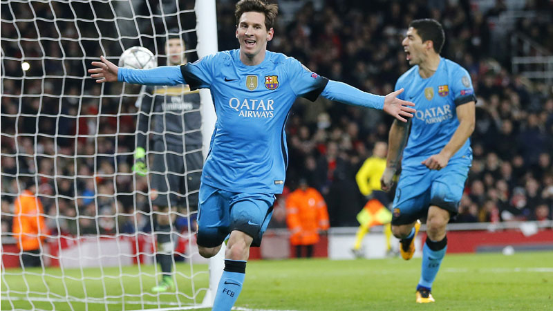 Barcelona's Lionel Messi, left, celebrates after he scored the second goal during the soccer Champions League round of 16 first leg soccer match between Arsenal and Barcelona at the Emirates stadium in London, Tuesday, Feb. 23, 2016. (AP Photo/Frank Augstein)